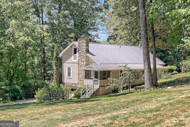 208 Colony Rd, Dillard, GA 30537 - view of front of home with a chimney, a front lawn, a standing seam roof, and stairway