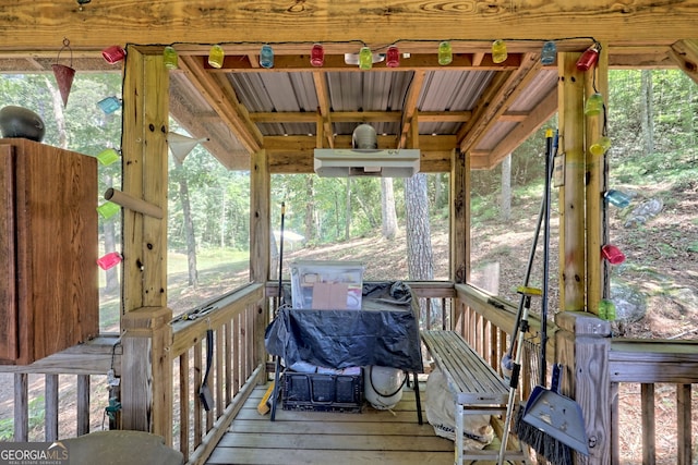 sunroom / solarium featuring wooden ceiling and a healthy amount of sunlight