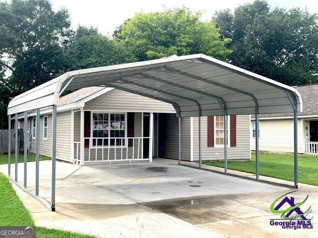 view of parking / parking lot featuring a carport