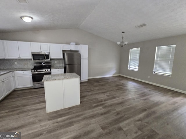 kitchen with decorative backsplash, pendant lighting, dark hardwood / wood-style flooring, stainless steel appliances, and white cabinetry