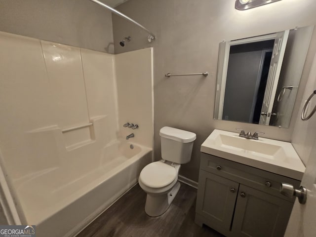 full bathroom featuring shower / bathing tub combination, wood-type flooring, vanity, and toilet