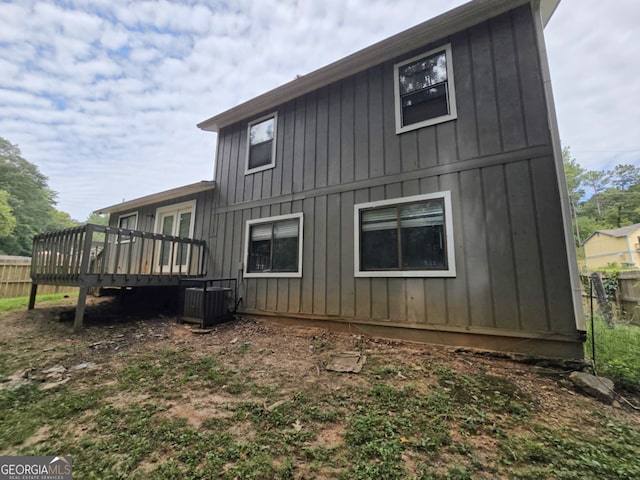 rear view of property featuring a deck and central air condition unit