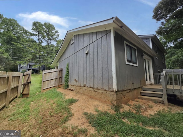 view of side of home featuring a wooden deck