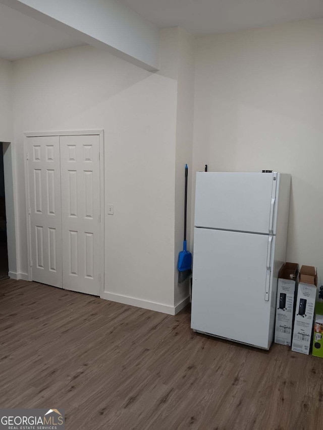 kitchen featuring white fridge and wood-type flooring