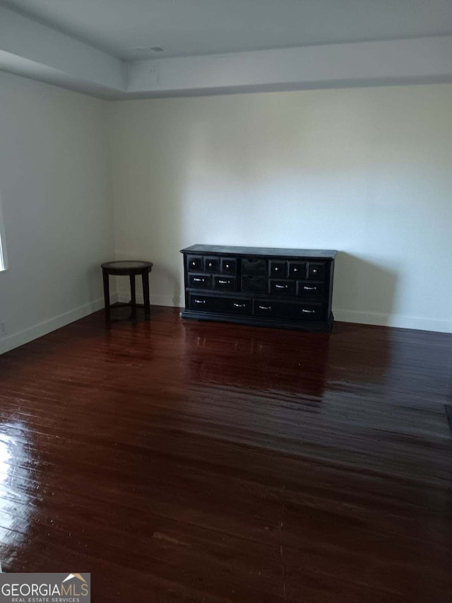 spare room featuring dark hardwood / wood-style flooring