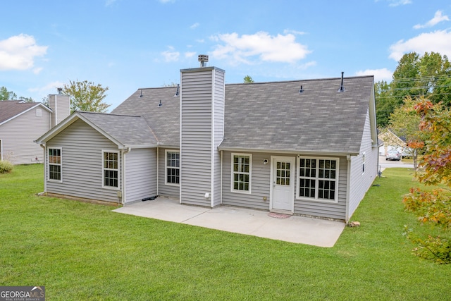 rear view of property featuring a yard and a patio area