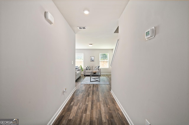 hallway with dark hardwood / wood-style flooring