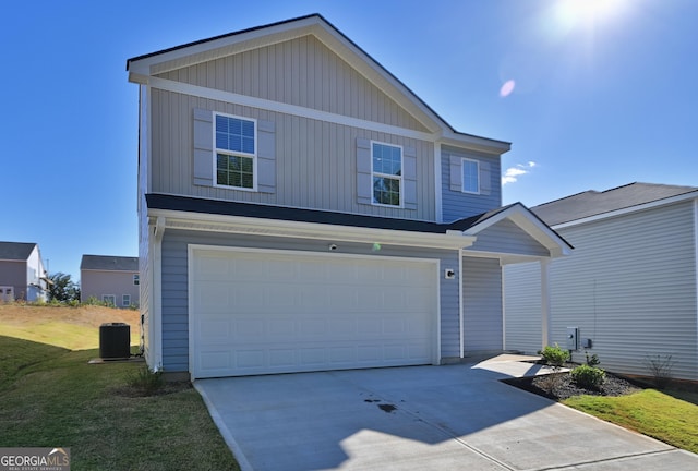 front of property with a front lawn, central AC unit, and a garage