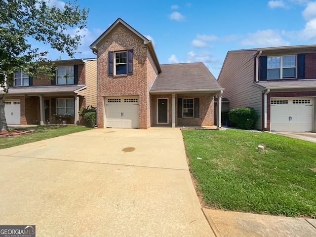 front of property featuring a garage, a front lawn, and covered porch