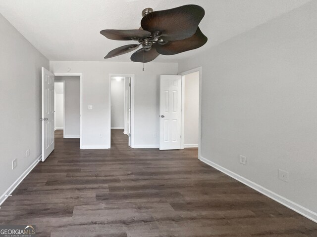 unfurnished bedroom featuring dark wood-type flooring and ceiling fan