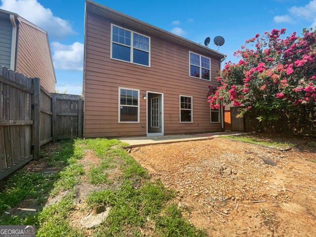 back of house with a patio area