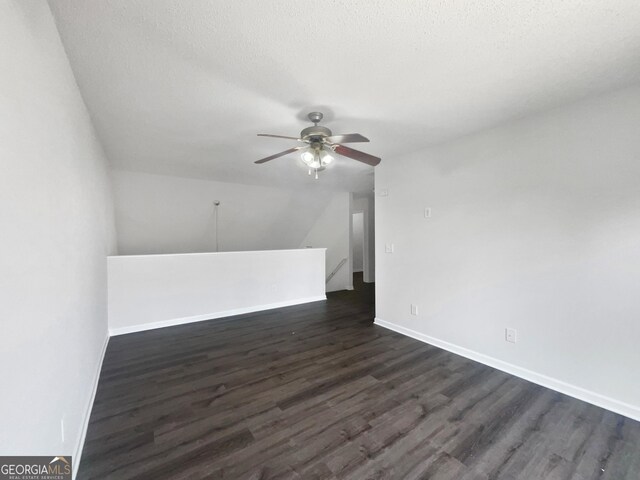 additional living space with a textured ceiling, dark hardwood / wood-style floors, and ceiling fan