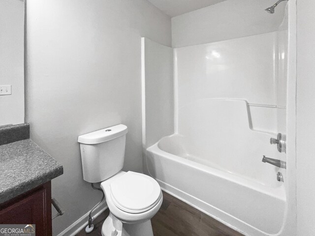 full bathroom featuring vanity, toilet,  shower combination, and wood-type flooring