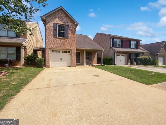 front facade featuring a garage and a front lawn