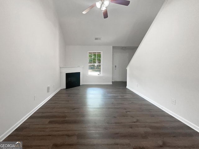 unfurnished living room featuring dark hardwood / wood-style flooring and ceiling fan