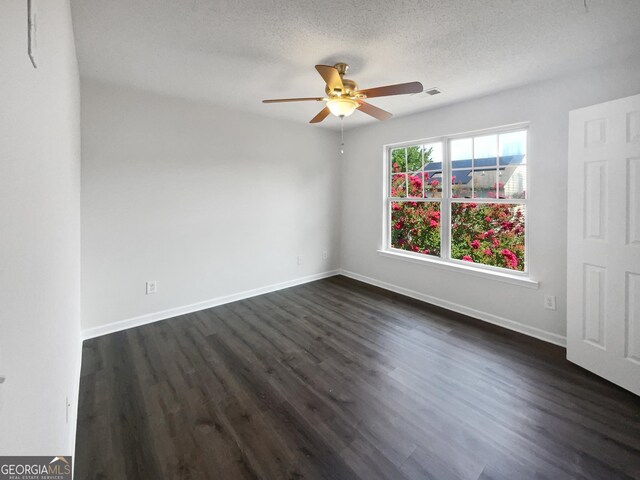 unfurnished room featuring dark hardwood / wood-style flooring, a textured ceiling, and ceiling fan