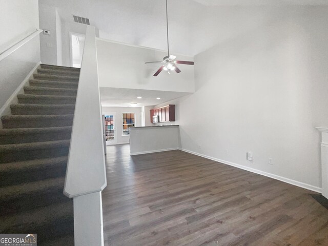 interior space featuring ceiling fan, dark hardwood / wood-style floors, and high vaulted ceiling