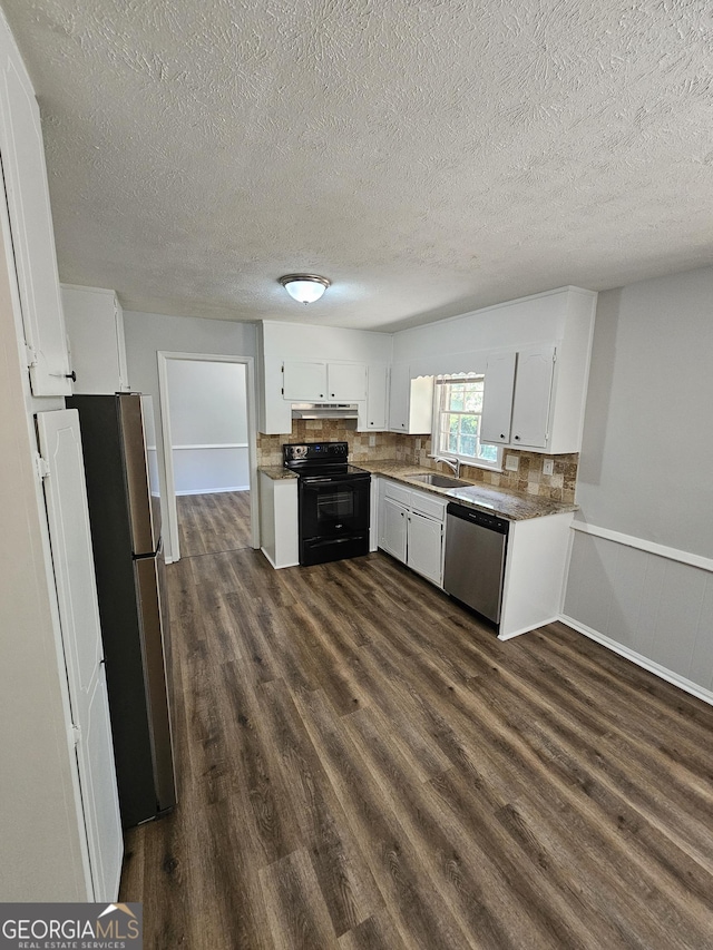 kitchen featuring appliances with stainless steel finishes, dark hardwood / wood-style floors, sink, white cabinets, and backsplash