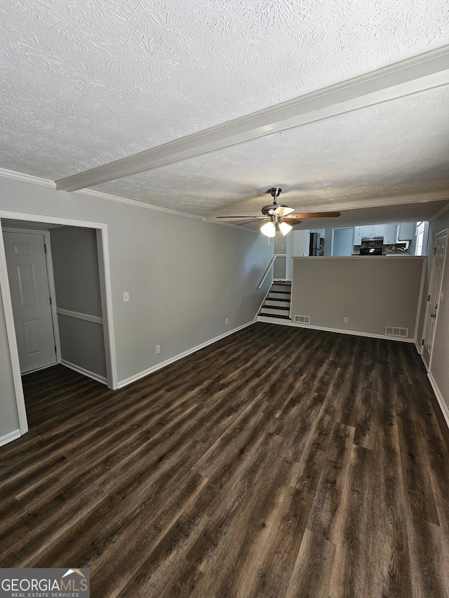 interior space with ceiling fan, dark hardwood / wood-style flooring, and a textured ceiling