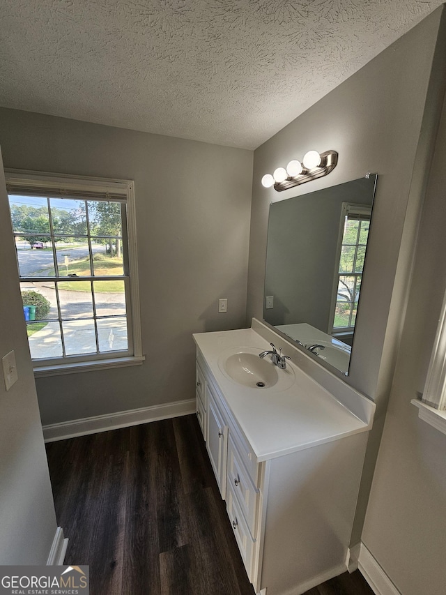 bathroom featuring vanity, hardwood / wood-style floors, and a textured ceiling