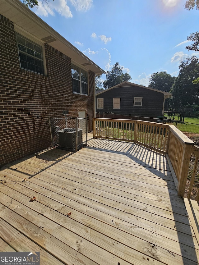 wooden deck featuring central air condition unit