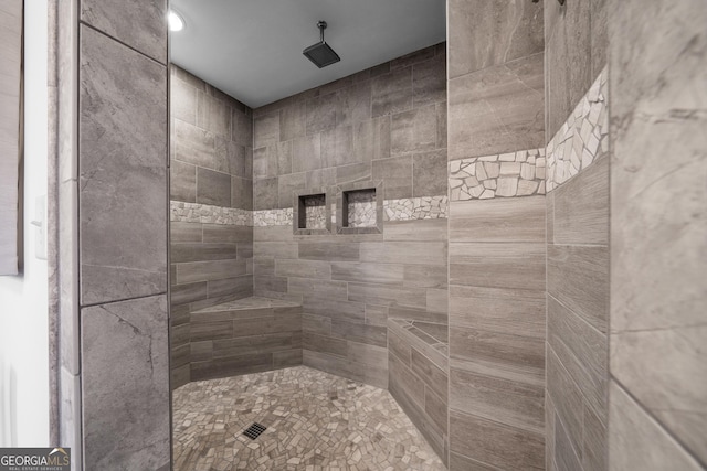 bathroom with tiled shower