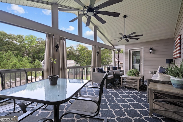 sunroom featuring ceiling fan and vaulted ceiling