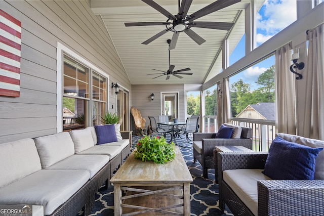 sunroom / solarium featuring ceiling fan and vaulted ceiling