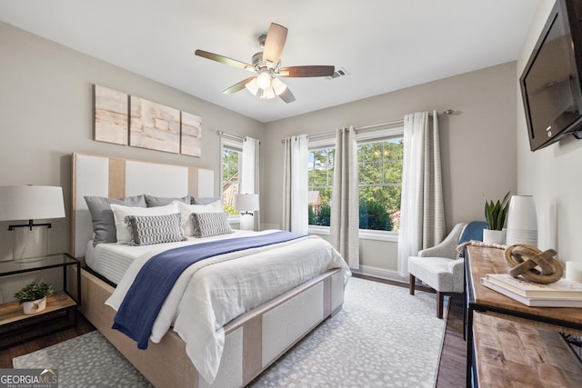 bedroom with light wood-type flooring and ceiling fan