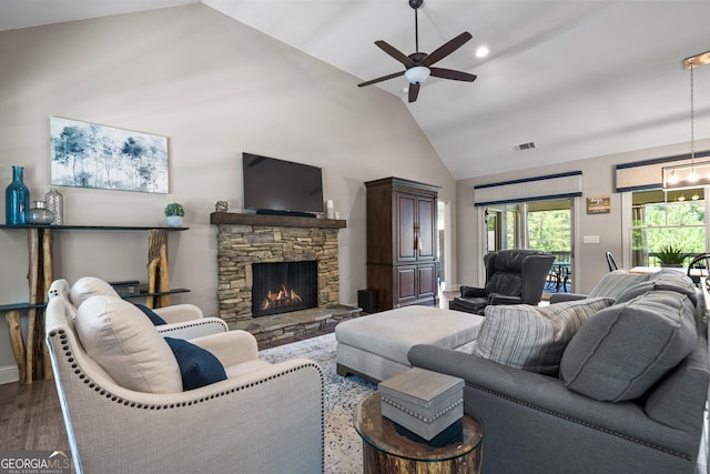 living room with ceiling fan, a fireplace, lofted ceiling, and dark wood-type flooring