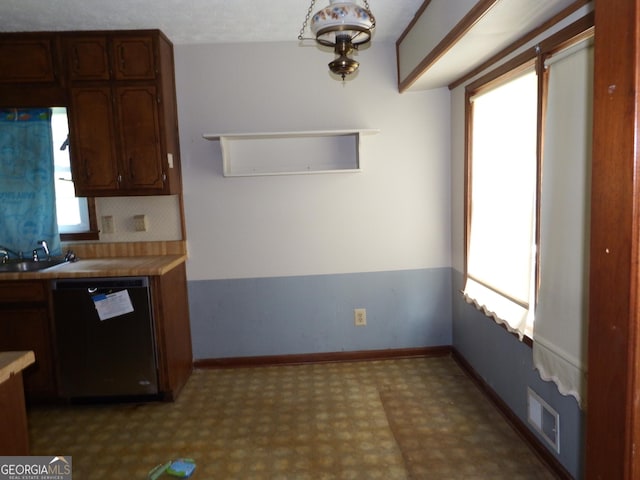 kitchen featuring black dishwasher and sink