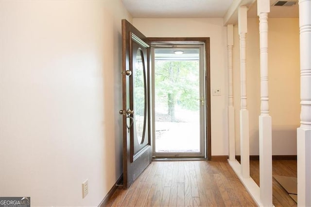 entryway with hardwood / wood-style floors