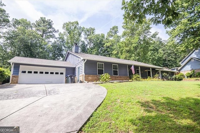 ranch-style home with a garage and a front lawn