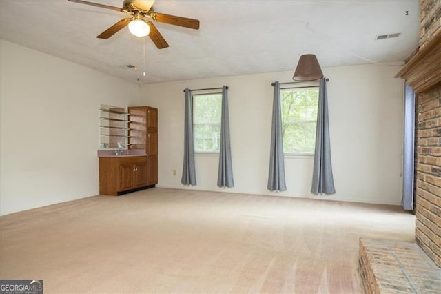 carpeted spare room featuring ceiling fan