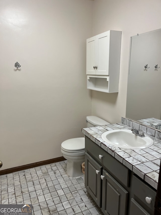 bathroom featuring vanity, toilet, and tile patterned floors