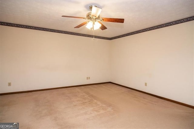 empty room featuring ceiling fan, carpet floors, crown molding, and a textured ceiling