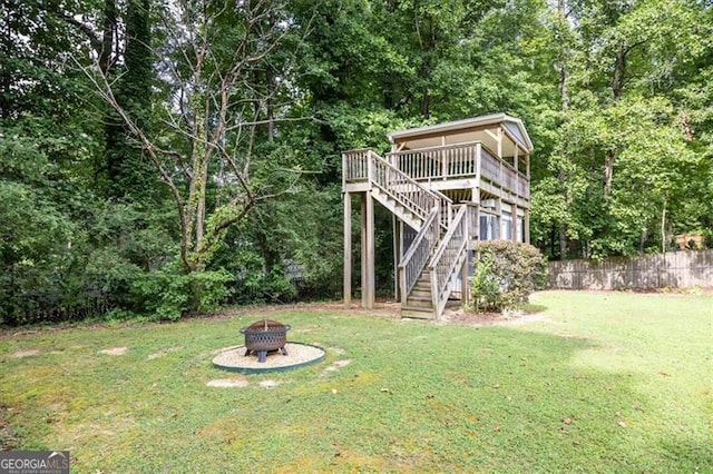 view of yard featuring a fire pit and a deck