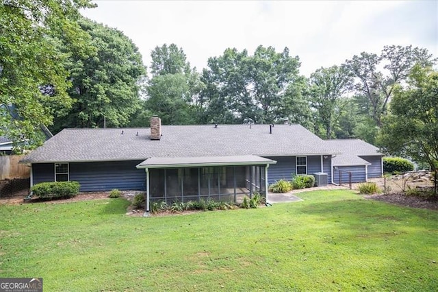 back of property featuring a lawn, central AC, and a sunroom