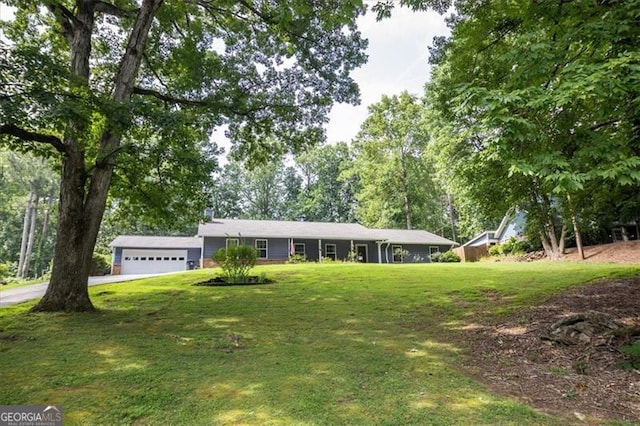 single story home with a garage and a front lawn