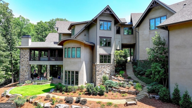 962 Chattooga Trce, Suwanee, GA 30024 - rear view of property featuring stucco siding, stone siding, a chimney, and a shingled roof