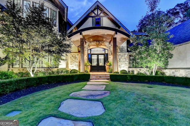 962 Chattooga Trce, Suwanee, GA 30024 - view of exterior entry with french doors, stone siding, stucco siding, and a yard