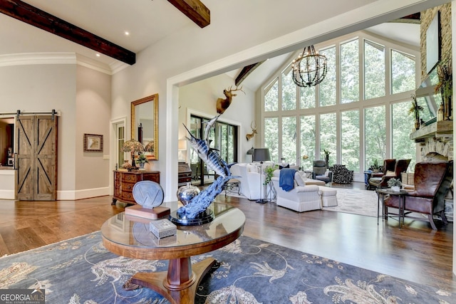 962 Chattooga Trce, Suwanee, GA 30024 - living area with a high ceiling, beam ceiling, wood finished floors, a barn door, and a chandelier
