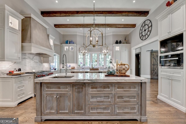 962 Chattooga Trce, Suwanee, GA 30024 - kitchen with a center island with sink, white cabinets, backsplash, a chandelier, and beam ceiling