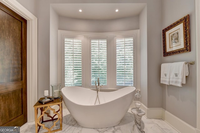 962 Chattooga Trce, Suwanee, GA 30024 - bathroom with marble finish flooring, a freestanding tub, and recessed lighting