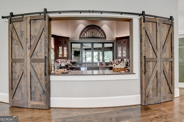 962 Chattooga Trce, Suwanee, GA 30024 - bar area with a barn door, wood finished floors, and dishwasher