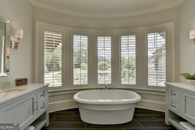 962 Chattooga Trce, Suwanee, GA 30024 - bathroom featuring vanity, a soaking tub, wood finish floors, and ornamental molding