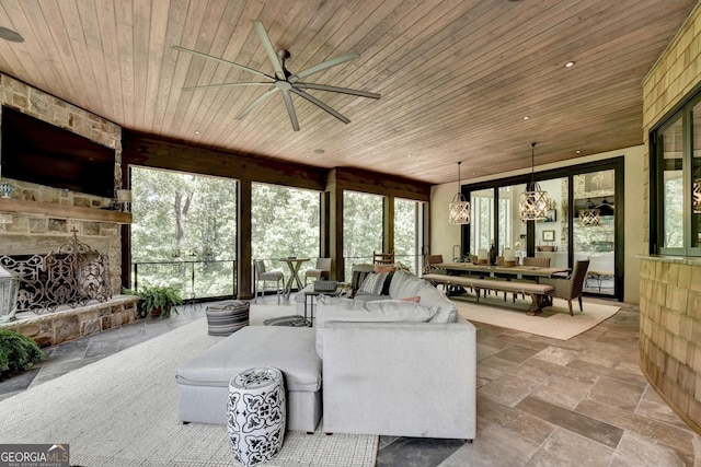 962 Chattooga Trce, Suwanee, GA 30024 - living area with wood ceiling, a ceiling fan, stone tile floors, a chandelier, and a fireplace