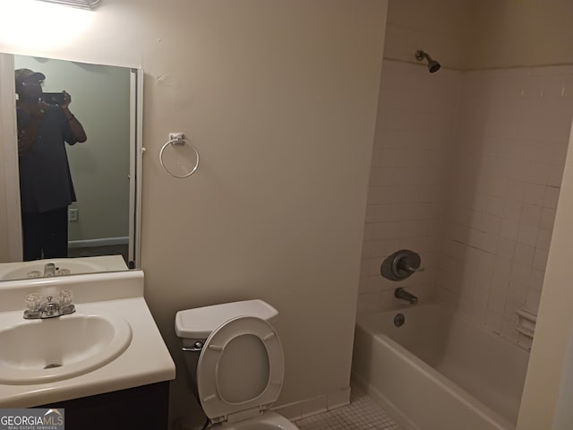 full bathroom with vanity, tiled shower / bath combo, toilet, and tile patterned flooring