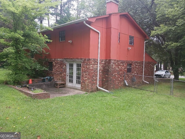 exterior space featuring french doors and a lawn