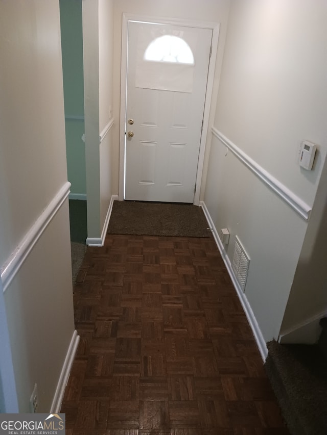 doorway to outside featuring dark parquet floors